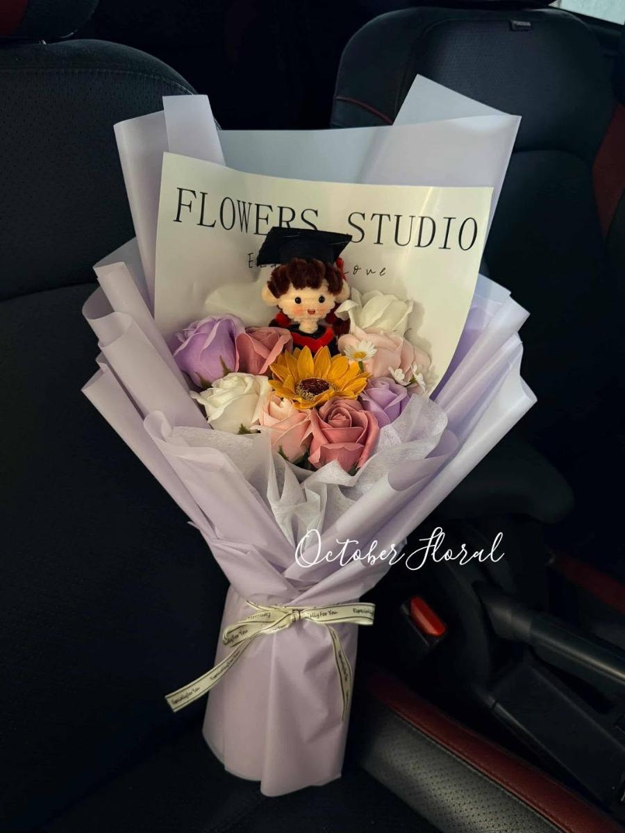 Light Purple Wrapped Graduation Bouquet Small Sunflower, and Graduate Cartoon Doll