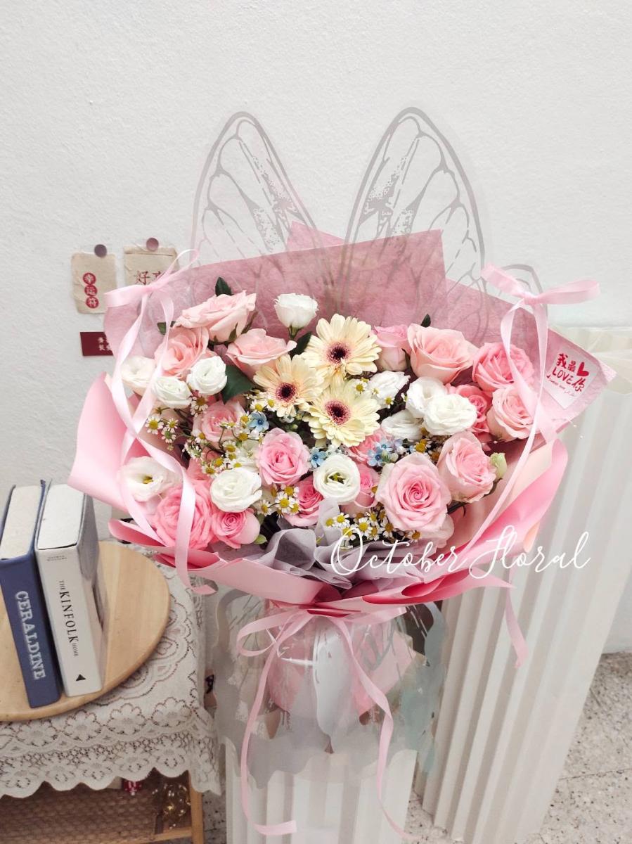 Angel Wings - Romantic Pink and White Wrapped Bouquet Adorned with Transparent Angel Wings, Pink Roses, and Small White Daisies